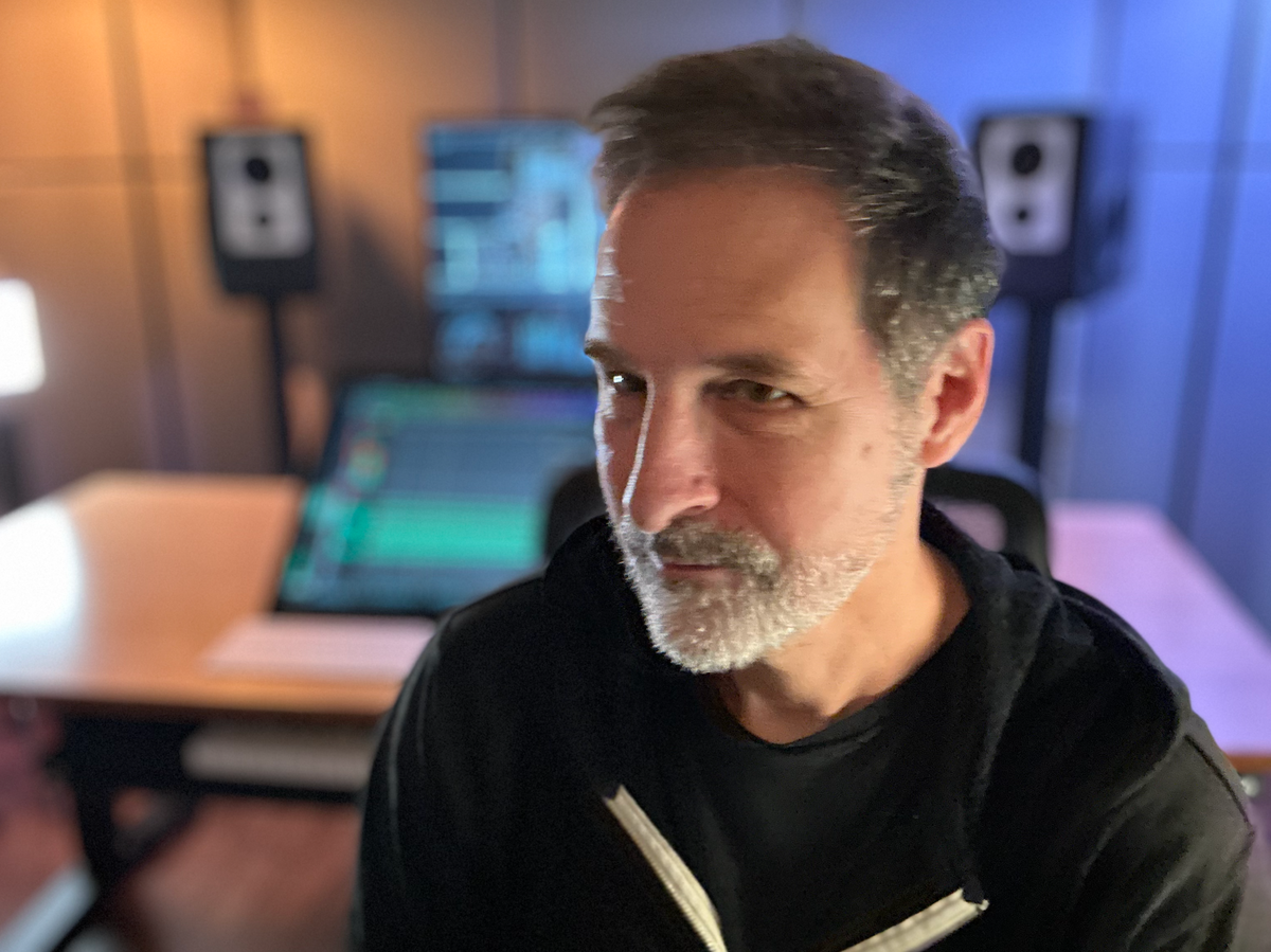 Bryan Leach in his studio, with his workstation and monitors behind him.