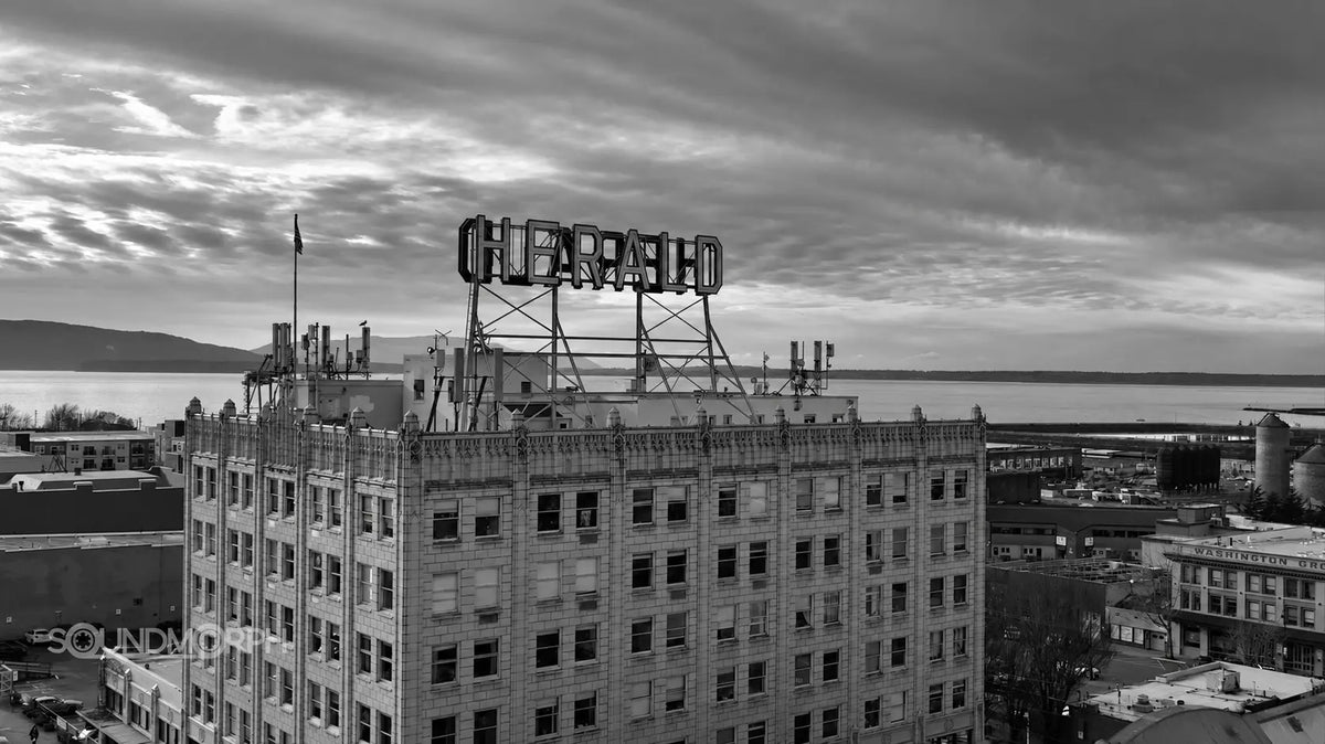 The Herald Building in Bellingham with the bay behind it, in black and white.