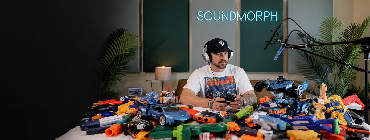 Jason Cushing in the studio with a colorful collection of toys for TOYED.